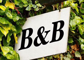 Bed and Breakfast sign hanging in trees